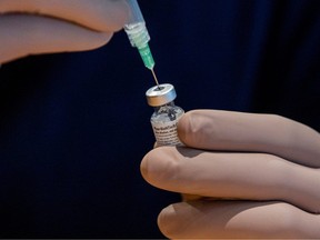 A healthcare worker prepares a dose of the Pfizer/BioNTech COVID-19 vaccine.