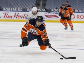 The Edmonton Oilers' Kailer Yamamoto (56) dives for a loose puck against the Toronto Maple Leafs at Rogers Place in Edmonton on Saturday, Feb. 27, 2021. The Leafs won 4-0.