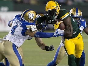 The Edmonton Elks' James Wilder Jr. (32) battles the Winnipeg Blue Bombers' Adam Bighill (4) during first half CFL action at Commonwealth Stadium, in Edmonton Saturday Sept. 18, 2021.