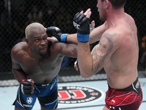 In this handout image provided by UFC, Derek Brunson, left, punches Darren Till of England in their middleweight fight during the UFC Fight Night event at UFC APEX on Sept. 4, 2021 in Las Vegas.