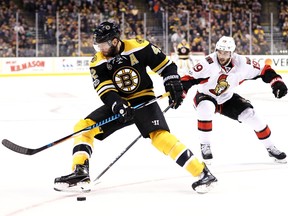 David Backes of the Boston Bruins skates against Derick Brassard of the Ottawa Senators at TD Garden on April 19, 2017 in Boston, Massachusetts.