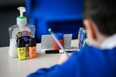 A bottle of hand sanitizer is seen on a pupil's desk.