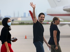 Former diplomat Michael Kovrig, his wife Vina Nadjibulla and sister Ariana Botha walk following his arrival on a Canadian air force jet after his release from detention in China, at Pearson International Airport in Toronto, Ontario, Canada September 25, 2021.  REUTERS/Chris Helgren