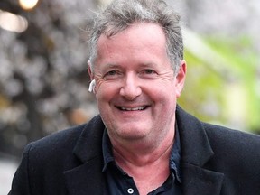 Journalist and television presenter Piers Morgan smiles as he walks near his house, after he left his high-profile breakfast slot with the broadcaster ITV, following his long-running criticism of Prince Harry's wife Meghan, in London, England, March 10, 2021.