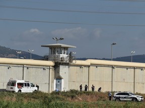 Israeli security personnel stand together during searches outside Gilboa prison after six Palestinian militants broke out of it in north Israel, Sept. 6, 2021.