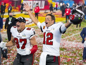 Tampa Bay Buccaneers quarterback Tom Brady (12) and tight end Rob Gronkowski (87) celebrate after beating the Kansas City Chiefs in Super Bowl LV at Raymond James Stadium.