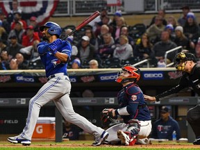 Toronto Blue Jays infielder Marcus Semien (10) hits a double off of Minnesota Twins starting pitcher Bailey Ober (82) during the first inning at Target Field.