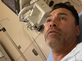 Oscar De La Hoya is pictured in hospital after revealing his COVID-19 diagnosis in a screengrab of a video posted on his Instagram account.