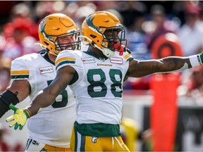 Edmonton Elks' Jalen Tolliver, right, celebrates his touchdown with teammate David Beard during first half CFL football action against the Calgary Stampeders in Calgary, Monday, Sept. 6, 2021.