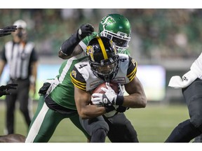 Saskatchewan Roughriders defensive end A.C. Leonard, shown here tackling on Papi White of the Hamilton Tiger-Cats, has been suspended by the CFL for two games for failing to provide a sample for drug testing. TROY FLEECE / Regina Leader-Post