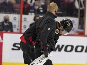 Senators centre Shane Pinto (12) is helped off the ice during the first period of Thursday's game against the Sharks with what initially appeared to be a shoulder injury. He returned for one shift in the second period, but did not play again after that.