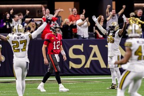 The Saints defence celebrates as Tampa Bay Buccaneers quarterback Tom Brady (12) walks back to the sideline after throwing an interception for a touchdown to cornerback P.J. Williams during the second half at Caesars Superdome.