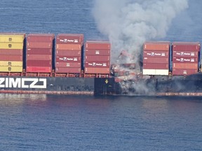 Smoke rises from the container ship Zim Kingston, burning from a fire on board, off the coast of Victoria, British Columbia, Canada October 23, 2021.