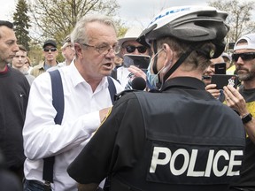 Randy Hillier, independent MPP for Lanark-Frontenac-Kingston argues with police at a protest against government measures to curb the spread of COVID-19, in Peterborough, Ont., Saturday, April 24, 2021.