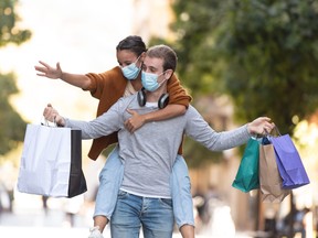 Young couple shopping in the street during pandemic