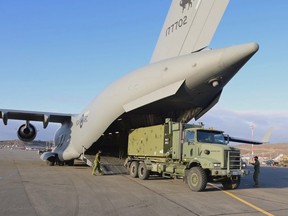 Canadian Forces equipment for Reverse Osmosis Water Purification is unloaded from a military transport aircraft, which was requested after officials in Nunavut said lab results confirmed that fuel had entered its water supply in Iqaluit, Saturday, Oct. 23, 2021.