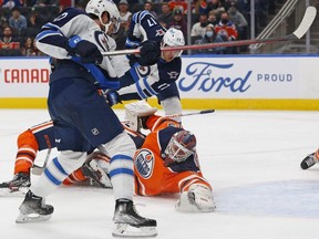 Oilers goaltender Mikko Koskinen makes a save on Jets’ Jansen Harkins last night.  USA TODAY Sports