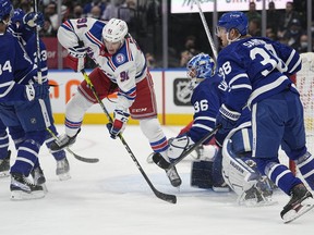 New York Rangers forward Sammy Blais tries to deflect a shot past Maple Leafs goaltender Jack Campbell as defenceman Rasmus Sandin looks on during the first period at Scotiabank Arena on Monday, Oct. 18, 2021.