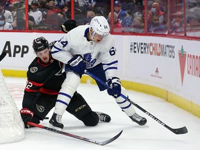 OTTAWA, ONTARIO - OCTOBER 14: Thomas Chabot #72 of the Ottawa Senators battles for the puck with David Kampf #64 of the Toronto Maple Leafs at Canadian Tire Centre on October 14, 2021 in Ottawa, Ontario. (Photo by Chris Tanouye/Getty Images)