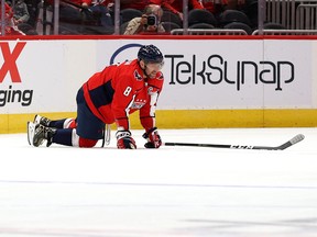 Alex Ovechkin of the Washington Capitals gets up slowly against the Philadelphia Flyers in the first period of a preseason game at Capital One Arena on Oct. 8, 2021 in Washington, D.C.
