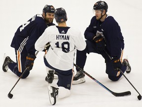 Zack Kassian (44), Zach Hyman (18) and Warren Foegele (37) have a chat after the Edmonton Oilers practice at the Downtown Community Arena on Wednesday, Oct. 6, 2021 in Edmonton.