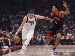 Mavericks' Luka Doncic drives against Scottie Barnes of the Raptors during NBA action at Scotiabank Arena in Toronto, Saturday, Oct. 23, 2021.