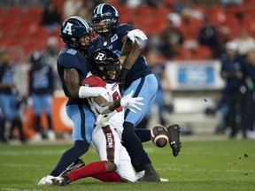 Ottawa Redblacks wide receiver R.J. Harris (84) drops the ball while Toronto Argonauts defensive back Chris Edwards (6) and Argonauts linebacker Dexter McCoil (26) keep close during first half CFL football action in Toronto on Oct. 6, 2021.