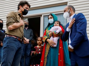 Prime Minister Justin Trudeau greets the Rahimi family (Ayat, Arezoo, Hawa, Obaidullah) who recently resettled in Ottawa from Afghanistan, in Ottawa, Oct. 9, 2021.
