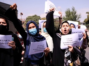 Afghan women's rights defenders and civil activists protest to call on the Taliban for the preservation of their achievements and education, in front of the presidential palace in Kabul, Sept. 3, 2021.