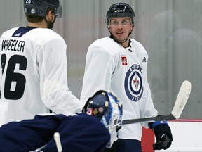 Nate Schmidt (right) speaks with Blake Wheeler as some Winnipeg Jets veterans skated at Bell MTS Iceplex in west Winnipeg on Wednesday, Sept. 16, 2021.