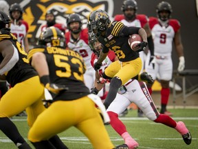 Tiger-Cats returner Brandon Banks (16) jumps as he tries to avoid Redblacks tacklers in the first half of Saturday's game at Hamilton.