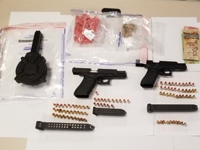 Toronto Police officers arrested three men and discovered a number of handguns -- including two Glock 9mm pistols with over-capacity extended magazines -- as well as a drum magazine, ammunition and a quantity of drugs and cash while executing a search warrant in the city on July 12, 2021.