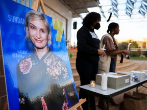 An image of cinematographer Halyna Hutchins, who died after being shot by Alec Baldwin on the set of his movie "Rust", is displayed at a vigil in her honour in Albuquerque, New Mexico, Saturday, Oct. 23, 2021.