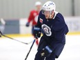 Andrew Copp picks up a pass during Winnipeg Jets training camp at BellMTS Iceplex in Winnipeg on Tuesday, Oct. 5, 2021.