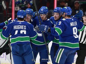 Elias Pettersson (centre) of the Vancouver Canucks is congratulated by teammates after scoring during their NHL game against the Dallas Stars at Rogers Arena on Sunday.