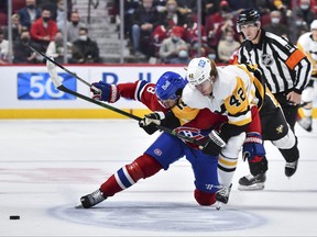 Ben Chiarot of the Montreal Canadiens and Kasperi Kapanen of the Pittsburgh Penguins skate after the puck during the second period on Thursday.