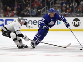 Toronto Maple Leafs right winger Ondrej Kase controls the puck past Los Angeles Kings' Adrian Kempe.