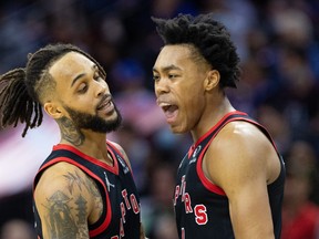 Toronto Raptors forward Scottie Barnes (R) reacts with guard Gary Trent Jr. (L) after a score against the Philadelphia 76ers during the fourth quarter at Wells Fargo Center.