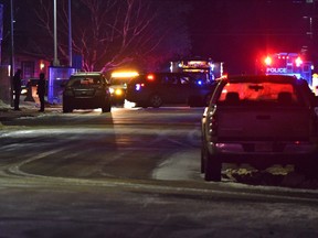 Police surround an area on 130 Avenue near 83 Street after a male suspect fled the scene of a ATB bank robbery on 97 Street and entered a residence that is not known to him in north Edmonton on Monday, Nov. 29, 2021.