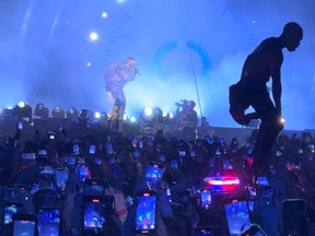 A man jumps on an ambulance standing in the crowd during the Astroworld music festiwal in Houston, Texas, Nov. 5, 2021 in this still image obtained from a social media video on Nov. 6, 2021.