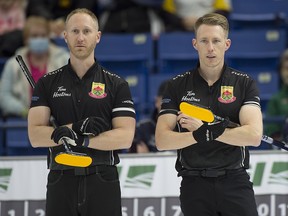 Skip Brad Jacobs of Sault Ste.Marie (left) and third Marc Kennedy look on during draw 16 against Team McEwen at the Candian Curling Trials in Saskatoon.