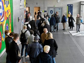 People queue up for a vaccine shot at a temporary vaccination centre inside the campus building of the Technische Universitaet in Dresden, Germany, Nov. 8, 2021.