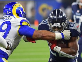 Jeremy McNichols, right, of the Titans is tackled by Aaron Donald of the Rams during the fourth quarter at SoFi Stadium in Inglewood, Calif., on Nov. 7, 2021.