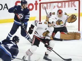 Winnipeg Jets' Neal Pionk scores on Chicago Blackhawks goaltender Marc-Andre Fleury.