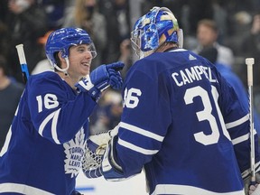 Maple Leafs' Mitchell Marner congratulates goaltender Jack Campbell after his shutout win against the Golden Knights at Scotiabank Arena in Toronto, Tuesday, Nov. 2, 2021.