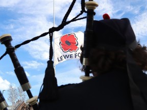 John Macdonald, of the Greater Sudbury Police Pipe Band, takes part in a flag-raising ceremony to mark the annual poppy campaign in Sudbury, Ont. on Friday, Oct. 29, 2021.