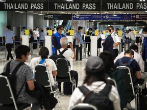 Foreign tourists prepare their documents at the new entry lanes at Suvarnabhumi Airport during the first day of the country's reopening campaign, part of the government's plan to jump start the pandemic-hit tourism sector in Bangkok, Thailand Nov. 1, 2021.