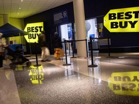 Black Friday shoppers leave a Best Buy store in Washington, D.C., on Nov. 26, 2021.