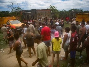 Crowds gather in Rio where the mutilated bodies of eight men were found.