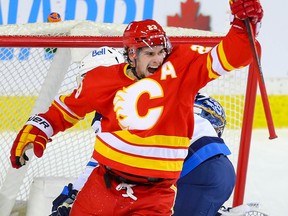 Calgary Flames Sean Monahan celebrates the game winner by Elias Lindholm against the Winnipeg Jets during NHL hockey in Calgary on Tuesday February 9, 2021. Al Charest / Postmedia